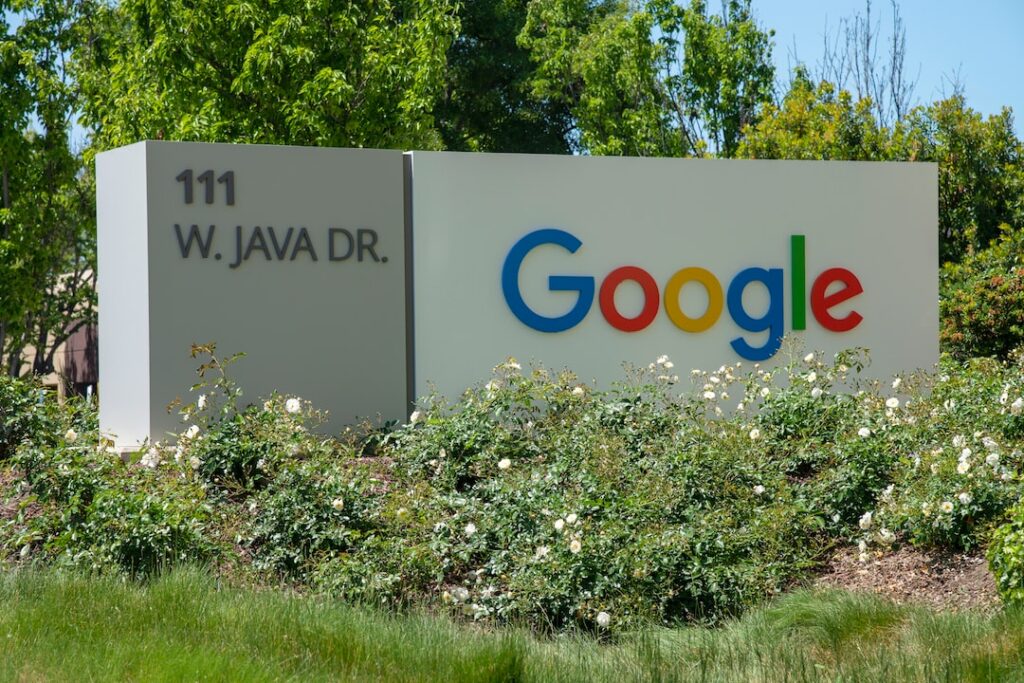 Google headquarters sign at 111 w. java dr. surrounded by greenery.