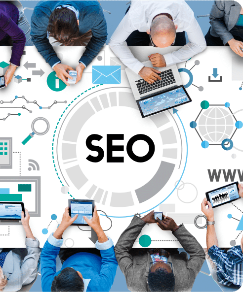 People sitting at a table with laptops, tablets, and smartphones, surrounded by digital icons, highlight the importance of SEO services with "SEO" prominently displayed in the center.