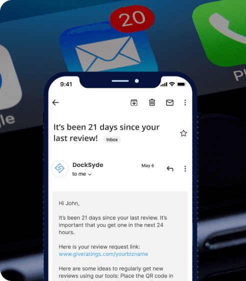 Close-up of a smartphone displaying an email reminder that it's been 21 days since the last review, with a badge showing 20 unread emails.