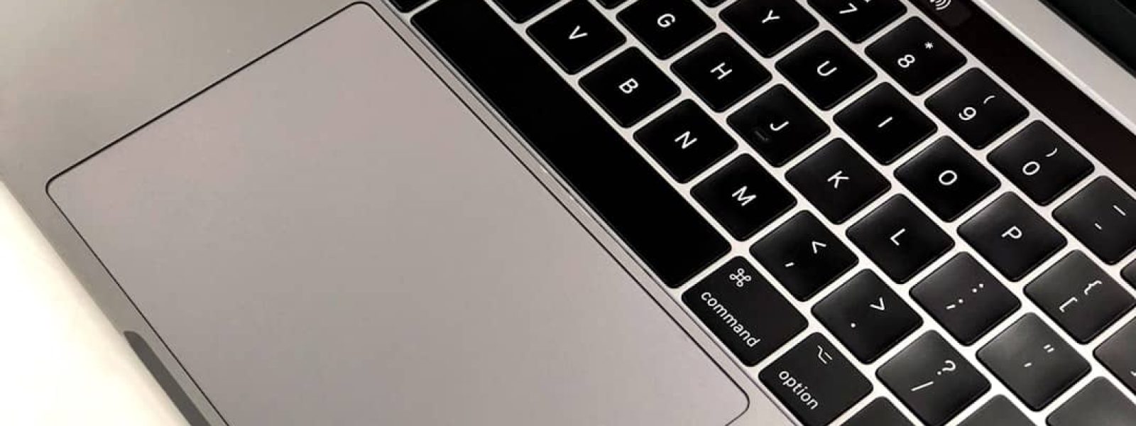 Silver laptop showing a close-up of the keyboard and touchpad.